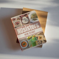 NUsisters New Start Cookbook placed on a chopping block.