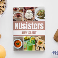 NUsisters New Start Cookbook on a counter with lemons, and lavender and granola.